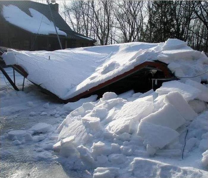 Fallen roof with heavy snow on top